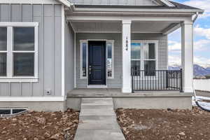 Property entrance with a mountain view and a porch