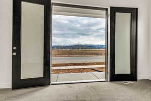 Entryway featuring a mountain view, carpet floors, and french doors