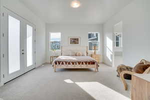 Bedroom with french doors, carpet, and access to exterior