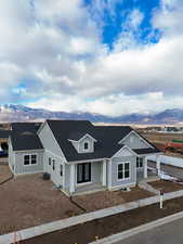 View of front of home with a mountain view and central AC