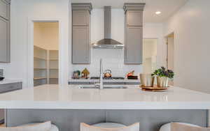 Kitchen with gray cabinetry and recessed lighting