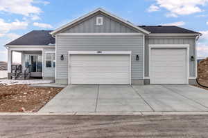 Single story home with a porch and a garage