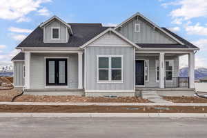 View of front of home with a mountain view and a porch