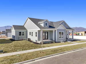 Modern farmhouse style home featuring a mountain view, covered porch, and board and batten siding