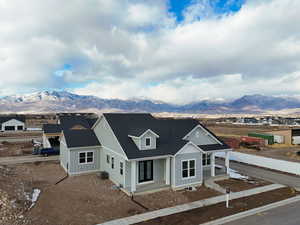 View of front of property featuring a mountain view and cooling unit