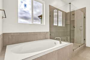 Bathroom featuring tile patterned flooring and independent shower and bath