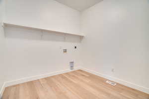 Laundry room featuring light wood-style flooring, washer hookup, and hookup for an electric dryer
