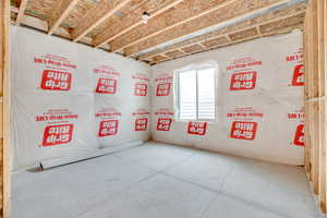 Spare room with unfinished concrete floors