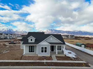 View of front of home with a mountain view and covered porch