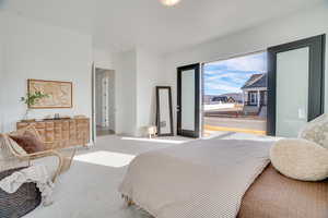 Bedroom featuring carpet and baseboards