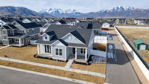 View of front of house featuring covered porch, roof with shingles, a mountain view, board and batten siding, and a residential view