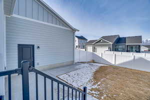 View of home's exterior with a patio area, board and batten siding, a fenced backyard, and a residential view