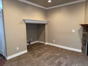 Washroom featuring dark carpet and ornamental molding