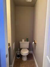 Bathroom featuring tile patterned floors, vanity, and toilet