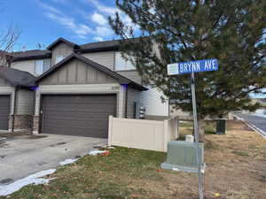 View of front facade featuring a front lawn and a garage