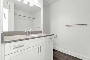 Bathroom with tile patterned flooring and vanity