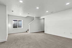 Interior space featuring carpet floors and a textured ceiling