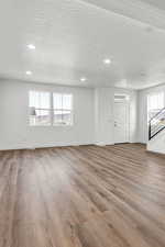 Empty room featuring light hardwood / wood-style floors and a textured ceiling