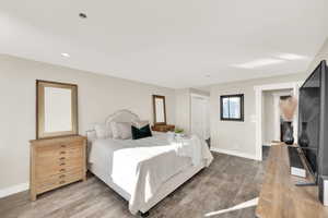 Bedroom featuring wood-type flooring and large double closet.