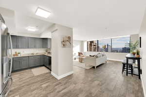 Living room/kitchen area and stunning South facing valley, mountain, and city views right from your condo.