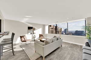 Living room with large windows opening up to gorgeous views of Salt Lake City, mountains, valley.