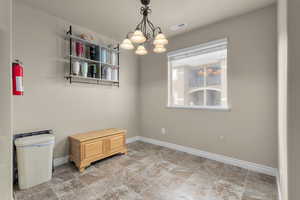 Empty room with an inviting chandelier