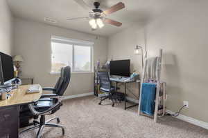 Office with carpet flooring and ceiling fan