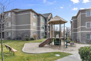 View of playground featuring a yard and cooling unit