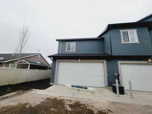 Rear of home with 2 car garage