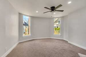 Empty room with ceiling fan and carpet