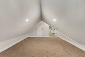 Bonus room featuring carpet floors and vaulted ceiling