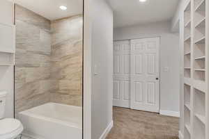 Bathroom featuring toilet and tiled shower / bath