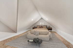 Carpeted bedroom with vaulted ceiling