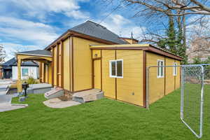 Rear view of property featuring a lawn