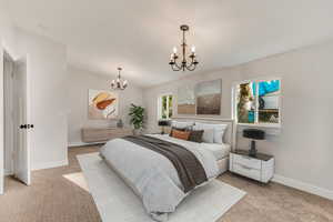 Carpeted bedroom with an inviting chandelier