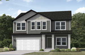 View of front facade featuring a garage and a front lawn