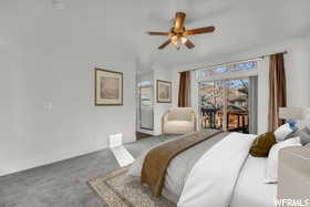 Bedroom with access to exterior, carpet floors, and ceiling fan