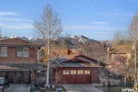 View of front facade featuring a mountain view and a garage