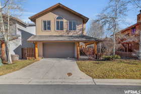 View of front of home featuring a garage and a front yard