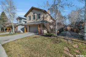 View of front property featuring a front yard and a garage