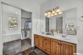 Bathroom with vanity and a tub to relax in