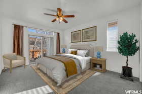 Carpeted bedroom with ceiling fan