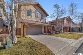 View of front of home featuring a front yard and a garage