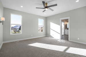 Carpeted spare room with ceiling fan