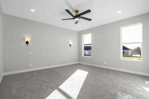 Spare room with carpet flooring, plenty of natural light, and ceiling fan