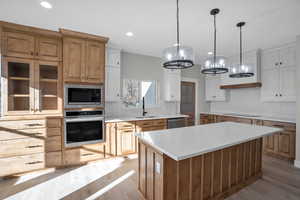 Kitchen featuring white cabinets, a center island, sink, and appliances with stainless steel finishes