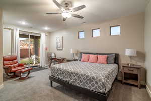 Bedroom featuring access to outside, dark carpet, and ceiling fan