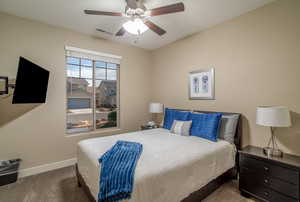 Carpeted bedroom with ceiling fan