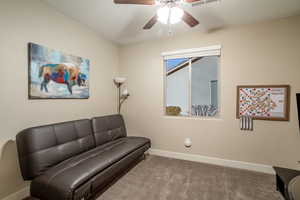 Living area with carpet and ceiling fan