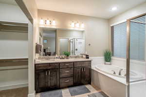 Bathroom featuring tile patterned flooring, vanity, and independent shower and bath